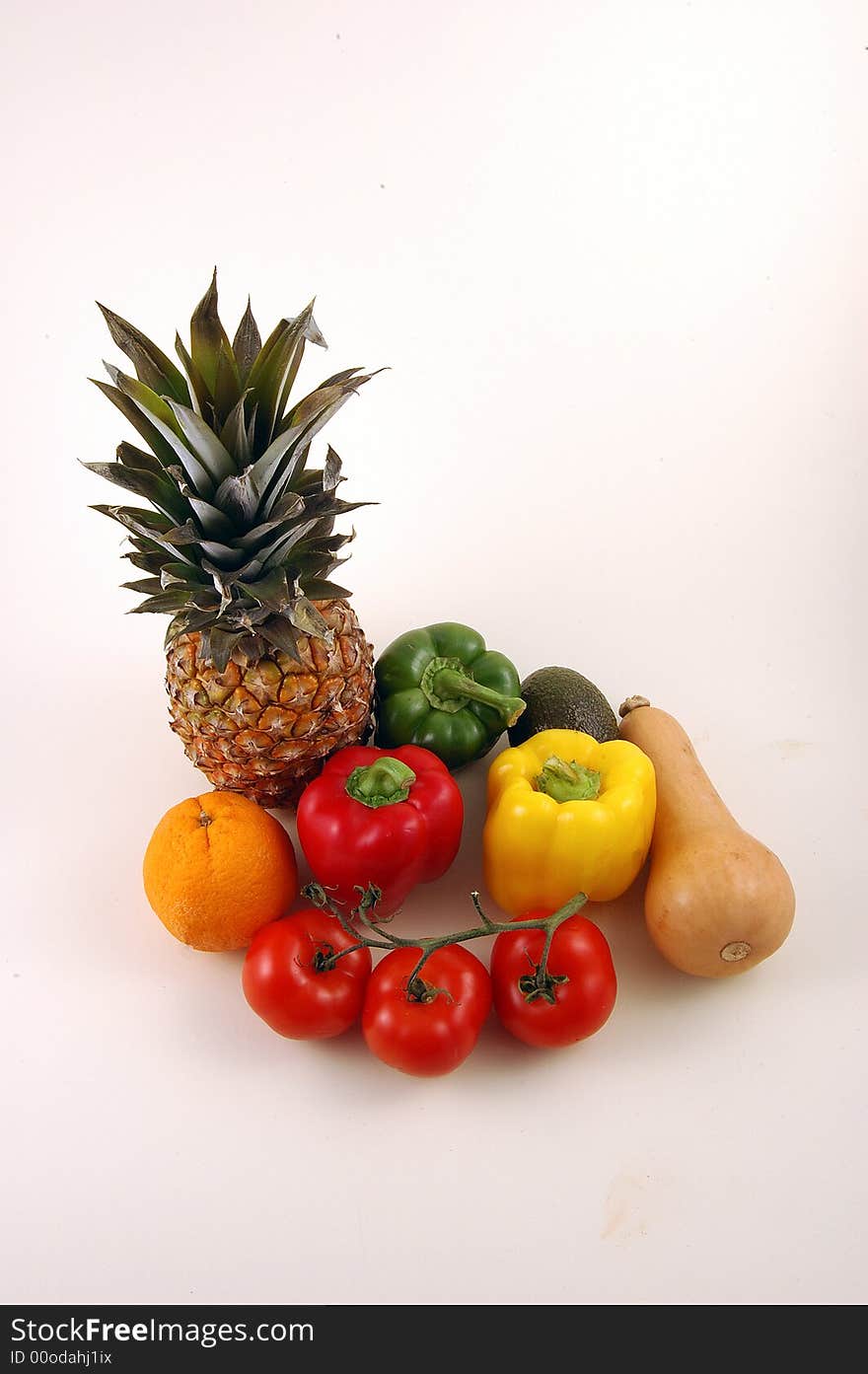 Pineapple and Vegetables on a white background, A collection of fruit and vegetables.Botanically speaking, a fruit is a seed-bearing structure that develops from the ovary of a flowering plant, whereas vegetables are all other plant parts, such as roots, leaves and stems. This includes such botanical fruits as eggplants, bell peppers and tomatoes. Pineapple and Vegetables on a white background, A collection of fruit and vegetables.Botanically speaking, a fruit is a seed-bearing structure that develops from the ovary of a flowering plant, whereas vegetables are all other plant parts, such as roots, leaves and stems. This includes such botanical fruits as eggplants, bell peppers and tomatoes