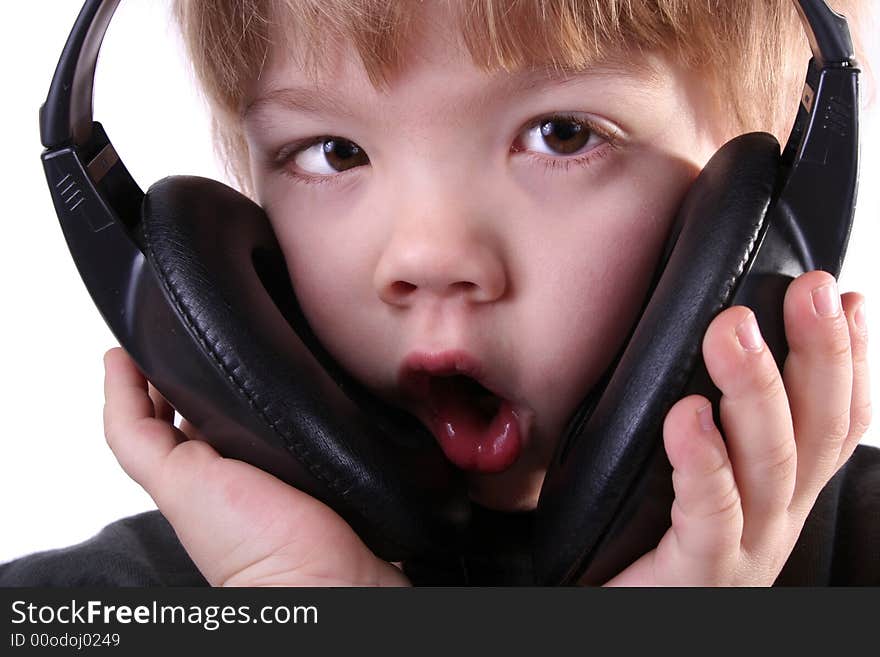 Little boy in headphones listens to music