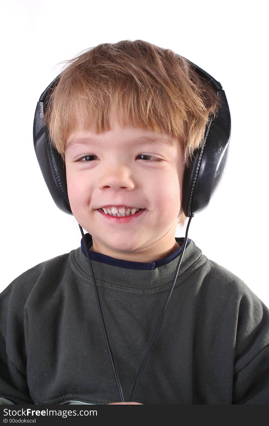 Little boy in headphones listens to music