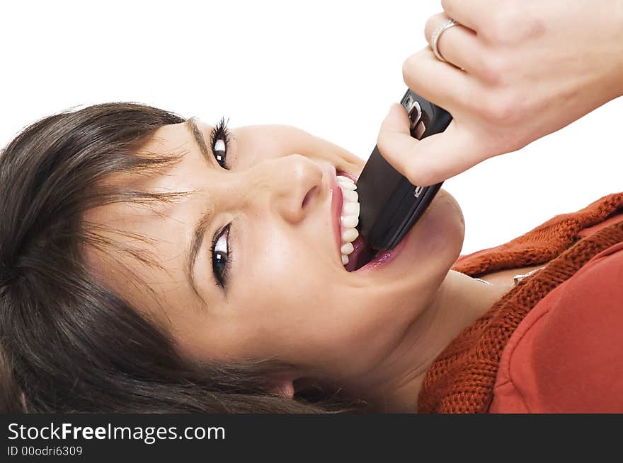 Young brunette girl with mobile phone on white background.