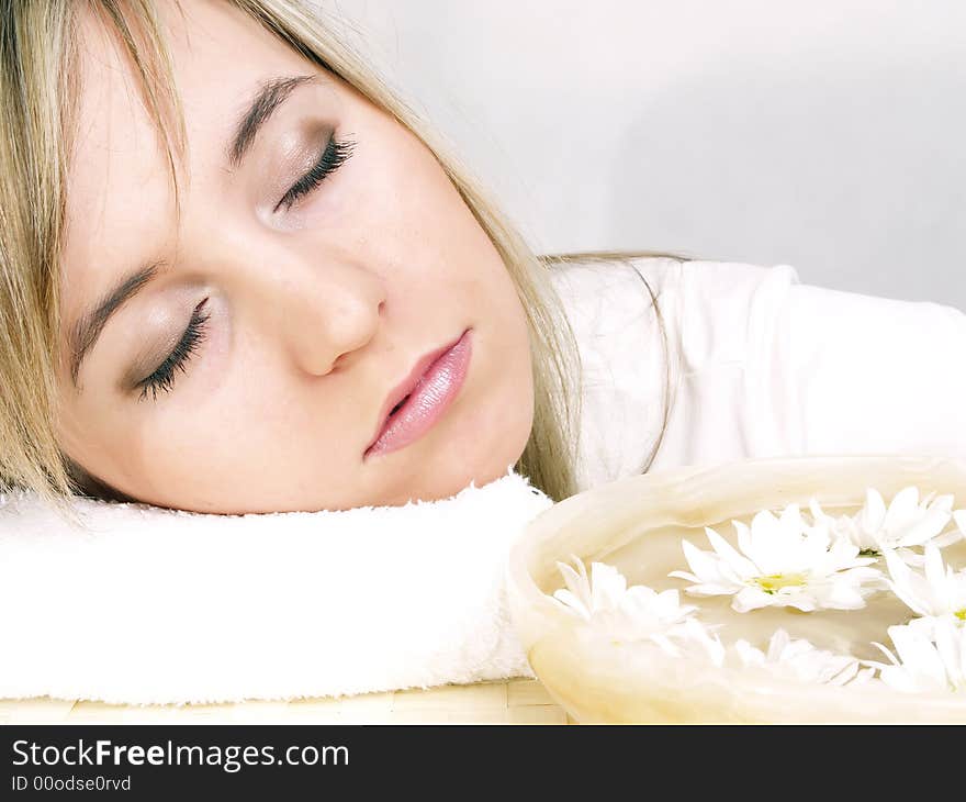 Close up of beautiful face and bowl full of flower. Close up of beautiful face and bowl full of flower