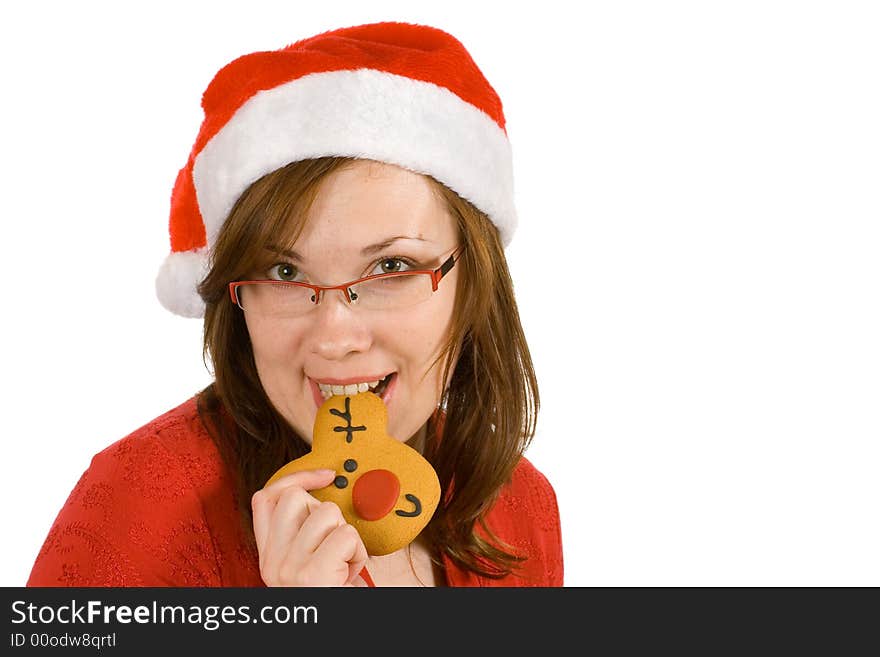 Santa girl with red specs and top, bite reindeer cookie. Santa girl with red specs and top, bite reindeer cookie