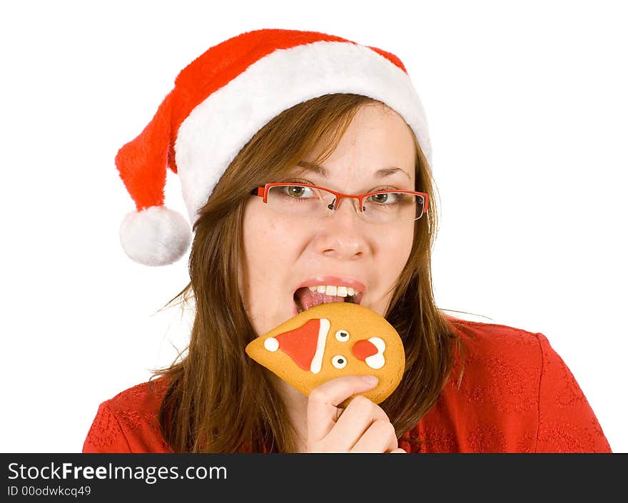 Santa girl with red specs and top, bite santa cookie. Santa girl with red specs and top, bite santa cookie