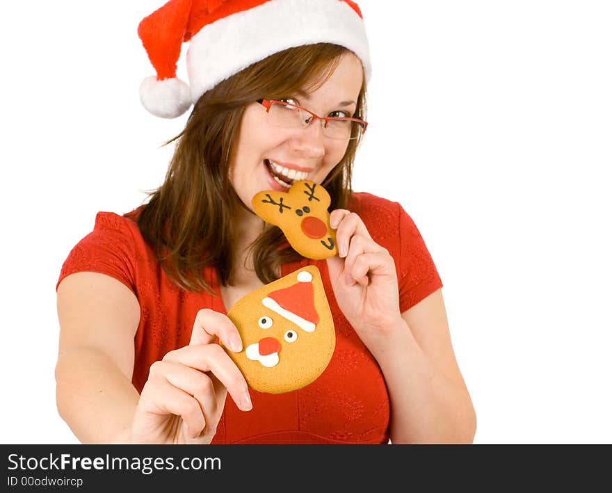 Santa girl with red specs and top, bite reindeer cookie. Santa girl with red specs and top, bite reindeer cookie