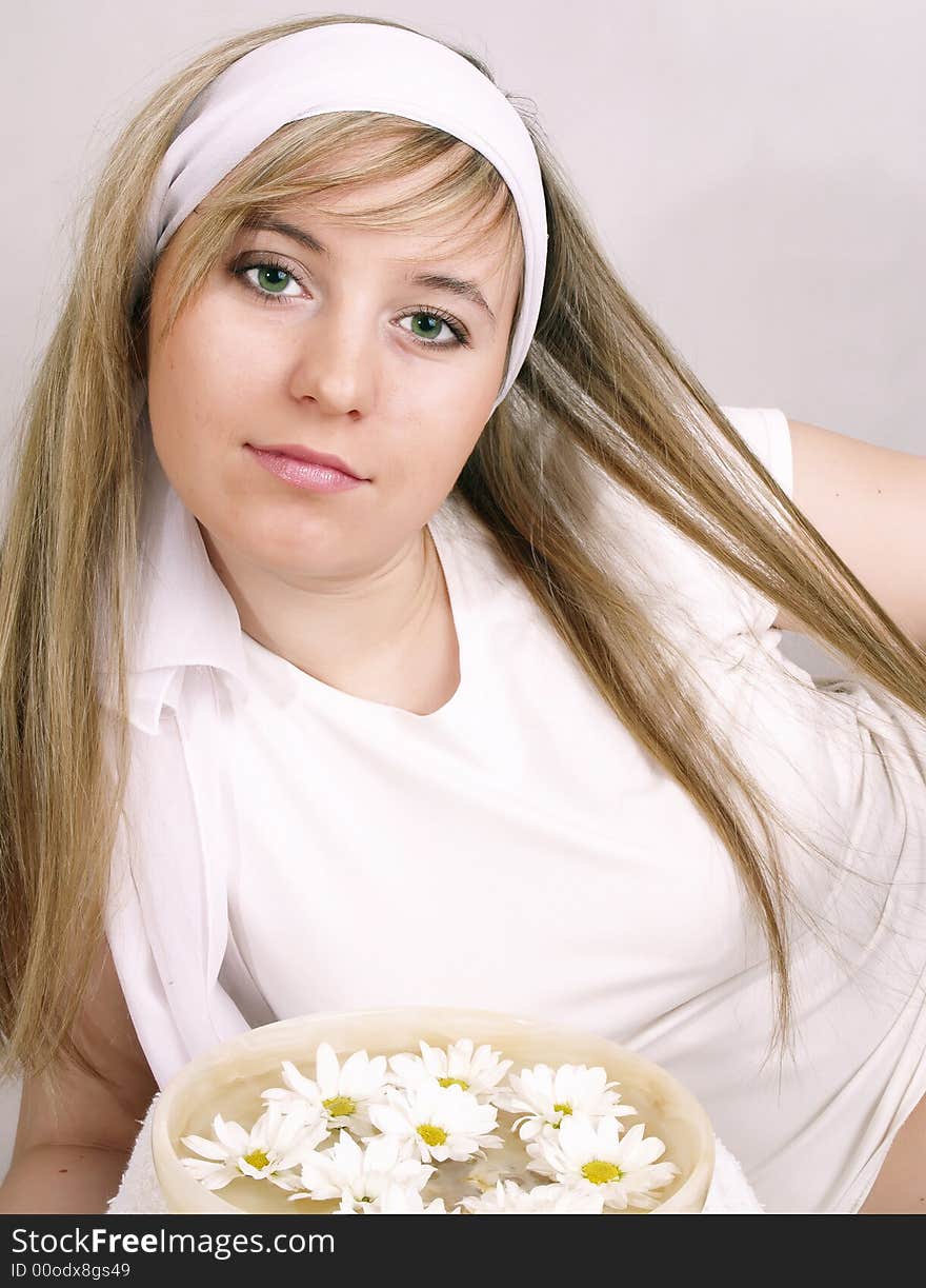 Close up of beautiful face and bowl full of flower. Close up of beautiful face and bowl full of flower