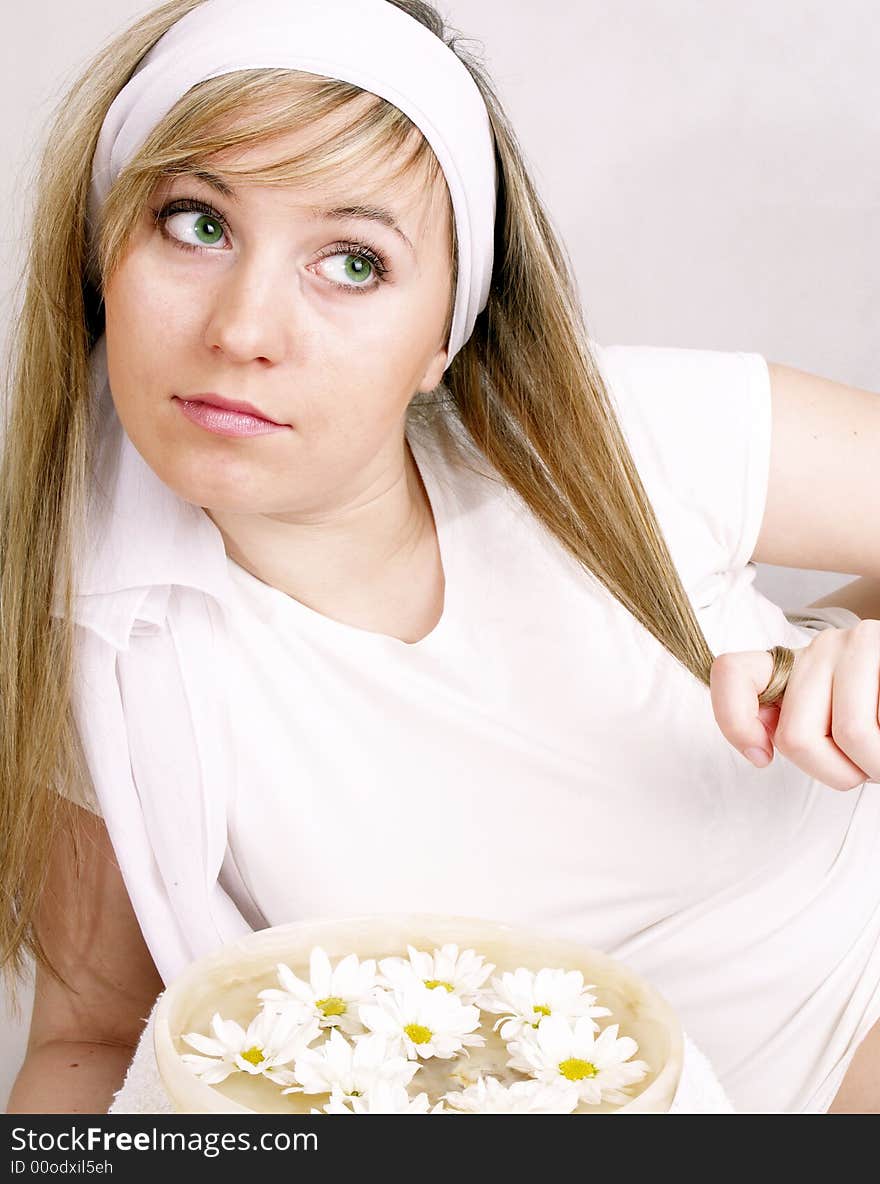 Close up of beautiful face and bowl full of flower. Close up of beautiful face and bowl full of flower