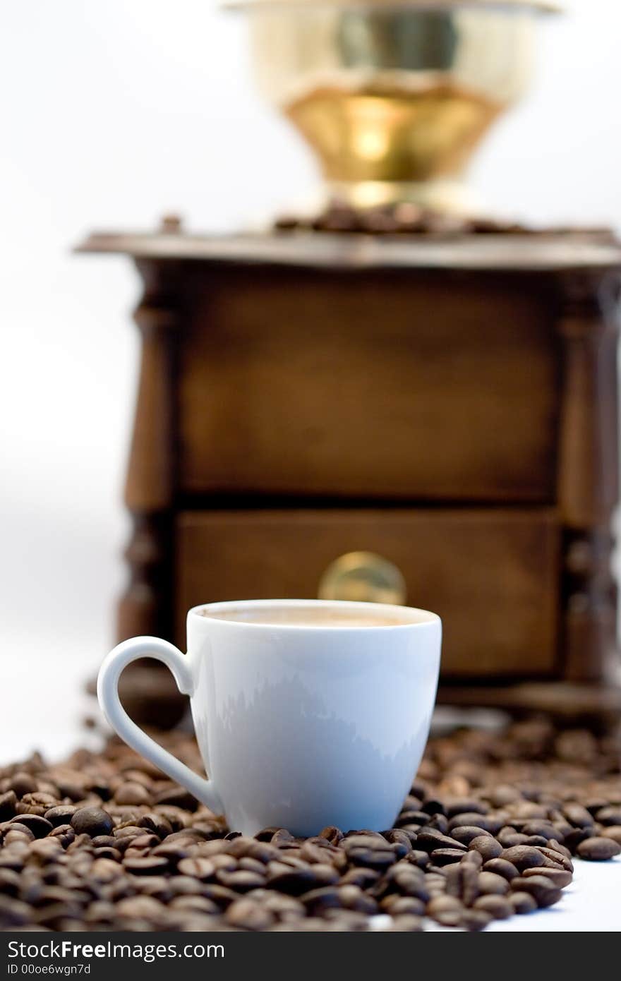 A Coffee Cup And A Coffee Grinder