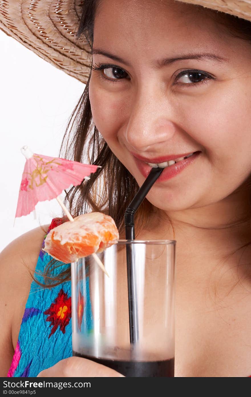 A woman wearing a summer clothing while sipping a cocktail drink