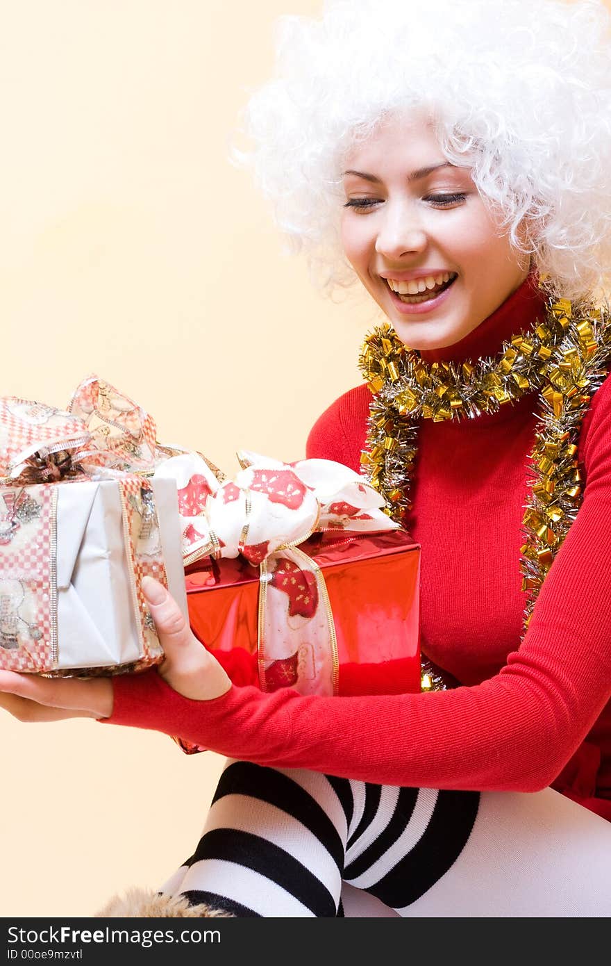 Beautiful young woman-santa with christmas gifts. Beautiful young woman-santa with christmas gifts