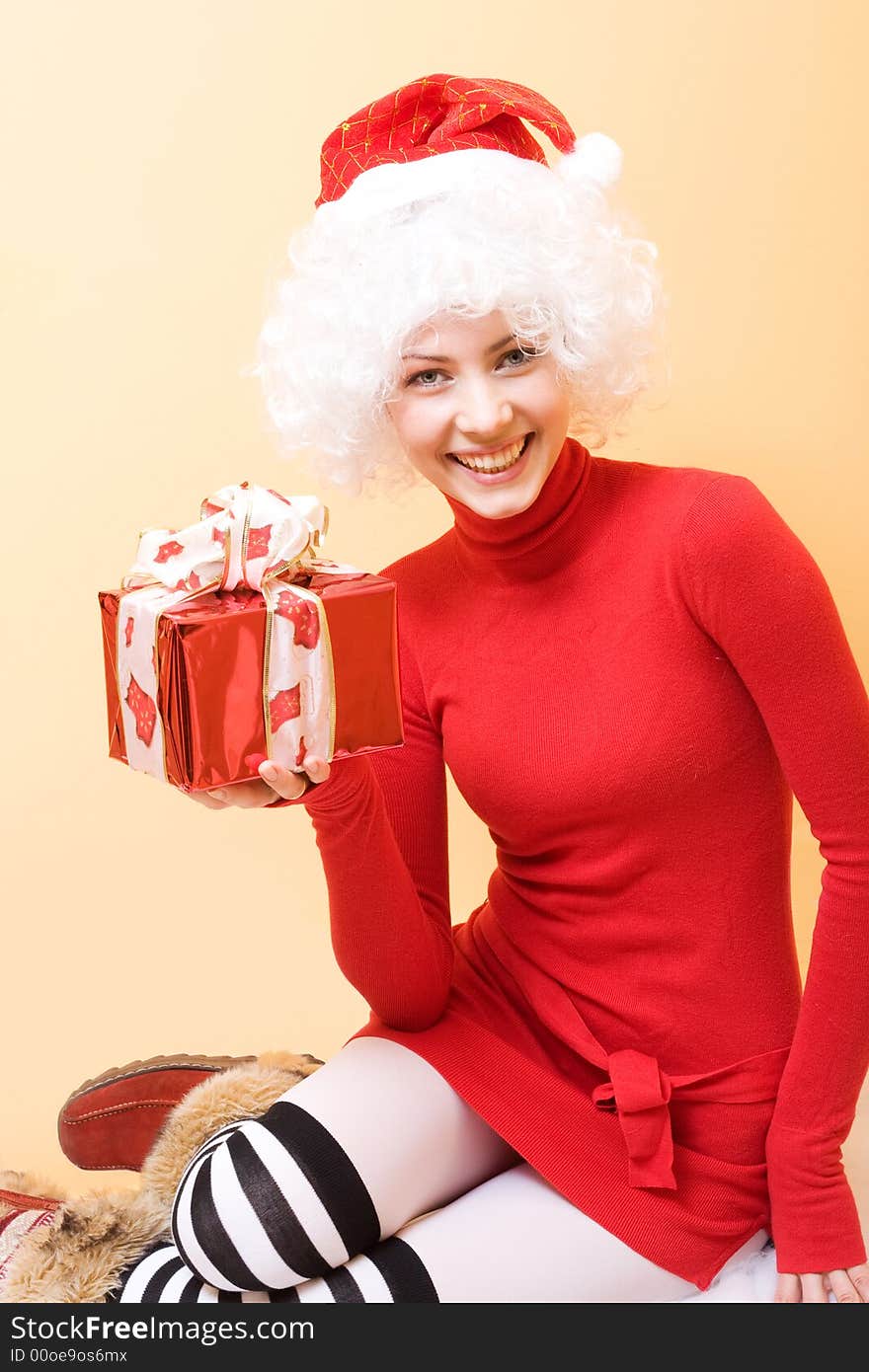 Beautiful young woman wearing santa hat with gifts. Beautiful young woman wearing santa hat with gifts