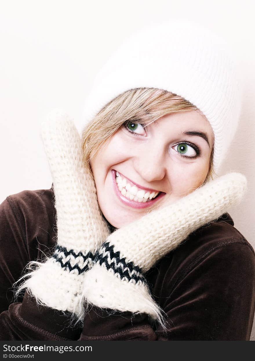 Closeup of young beautiful girl, wearing wool winter hat and gloves