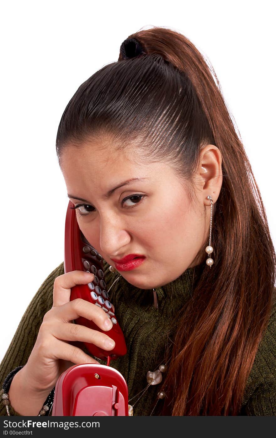 A young female talking on the phone looking unhappy. A young female talking on the phone looking unhappy