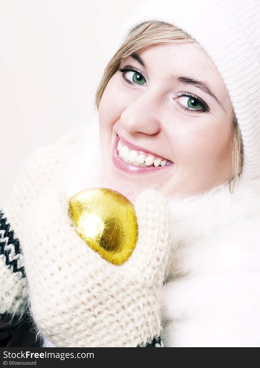 Closeup of young beautiful girl, wearing wool winter hat and scarf