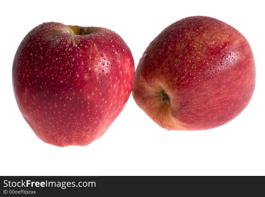 Two red apples with drops isolated