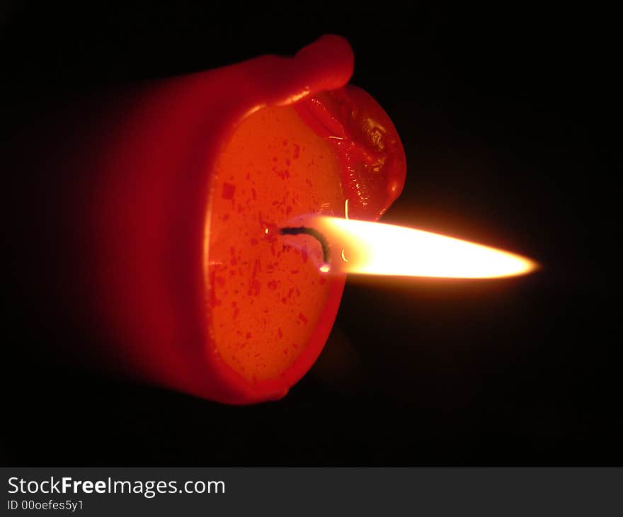 Red candle on a black background