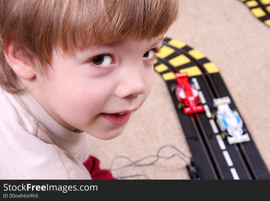 Little boy playing with toy car