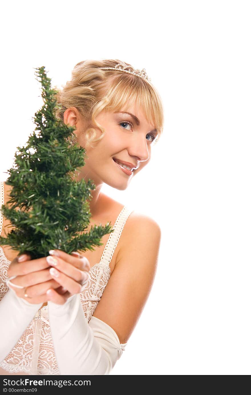 Beautiful blond girl holding a Christmas tree isolated on white background