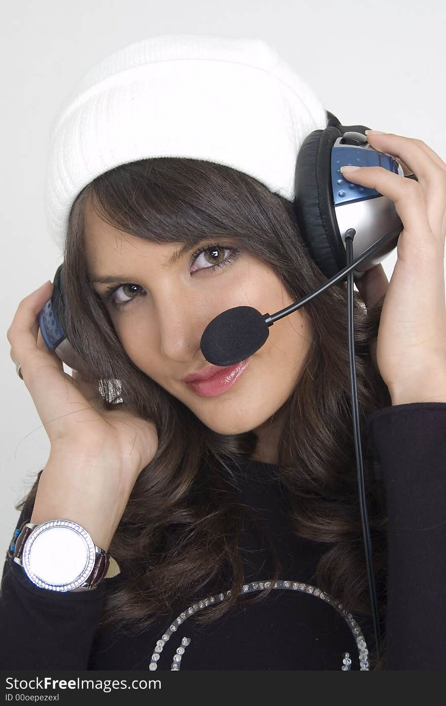 Pretty young woman with headphones and a cap