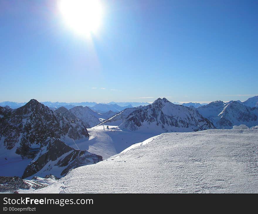 Sun over snowy mountain scene. Sun over snowy mountain scene