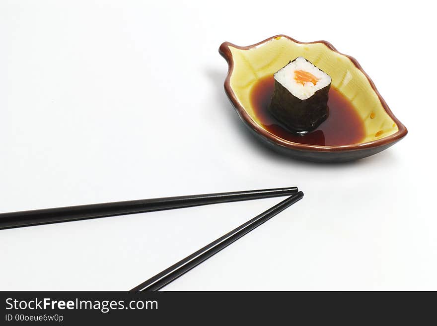 Sushi in a ceramic cup and wood sticks