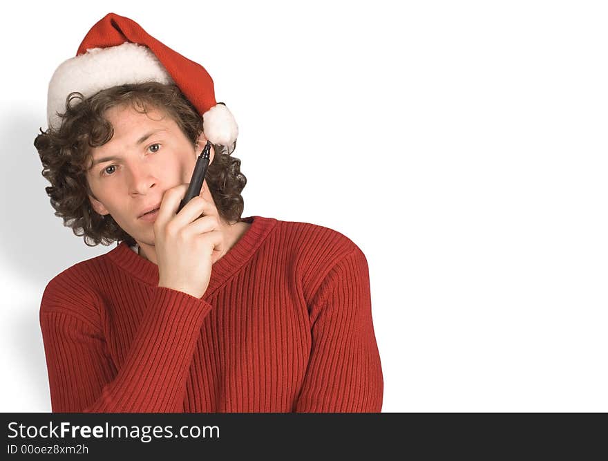 Young the man in cap Santa Claus with a pencil on white background. Young the man in cap Santa Claus with a pencil on white background