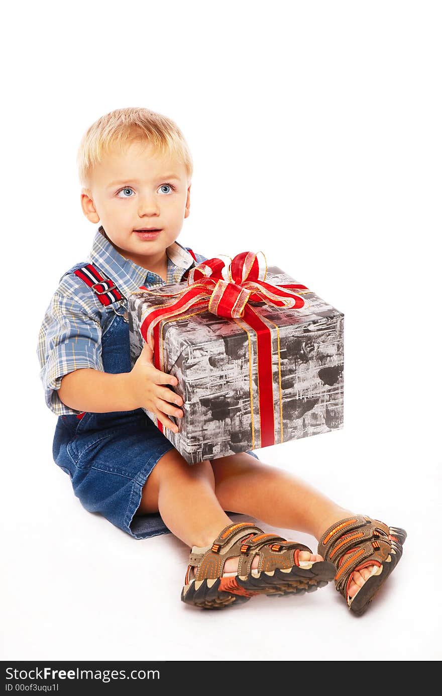 Cute blue-eyed child wiht gift in hands. Cute blue-eyed child wiht gift in hands