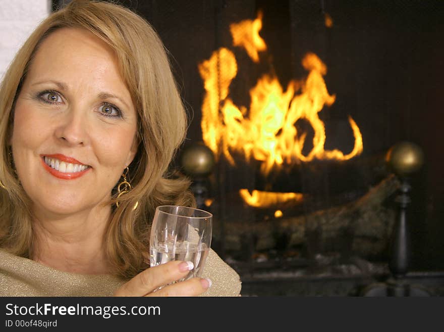 Shot of a stunning woman in front of fireplace