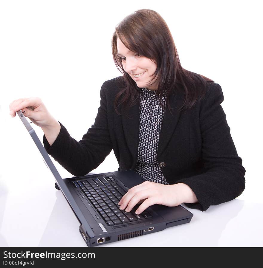 Young woman looks at her laptop isolated on white