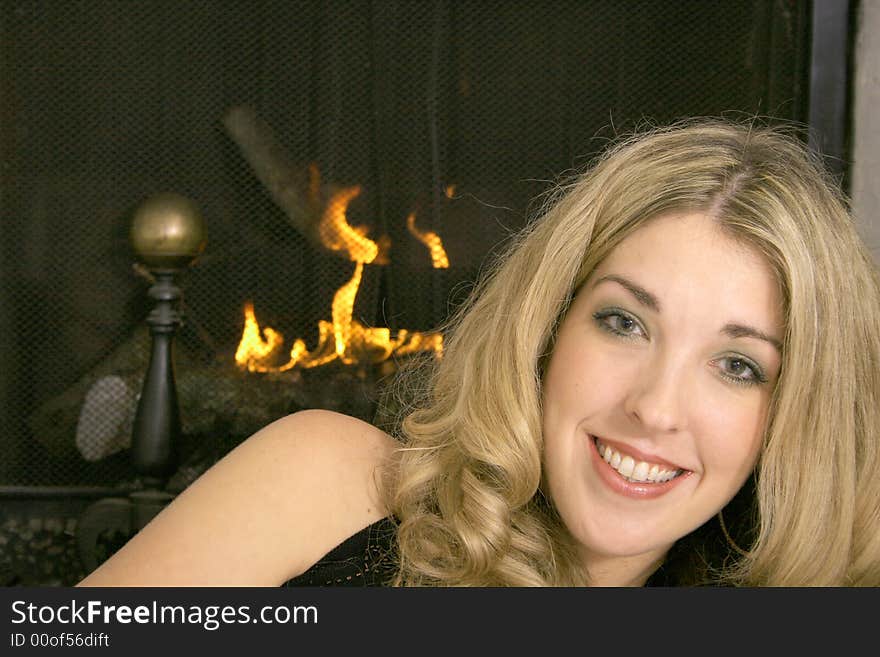 Happy blonde by the fire