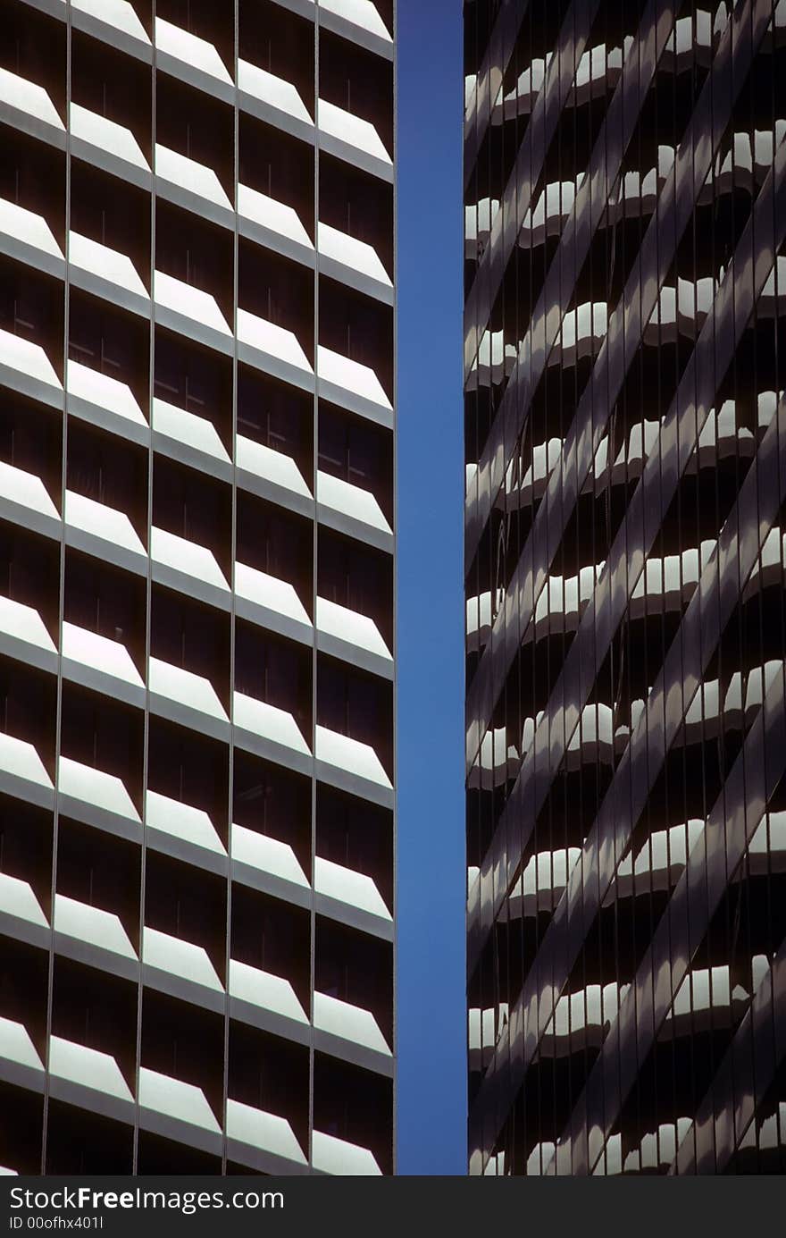 Modern building with grid structure and reflected in nearby glass building. Modern building with grid structure and reflected in nearby glass building