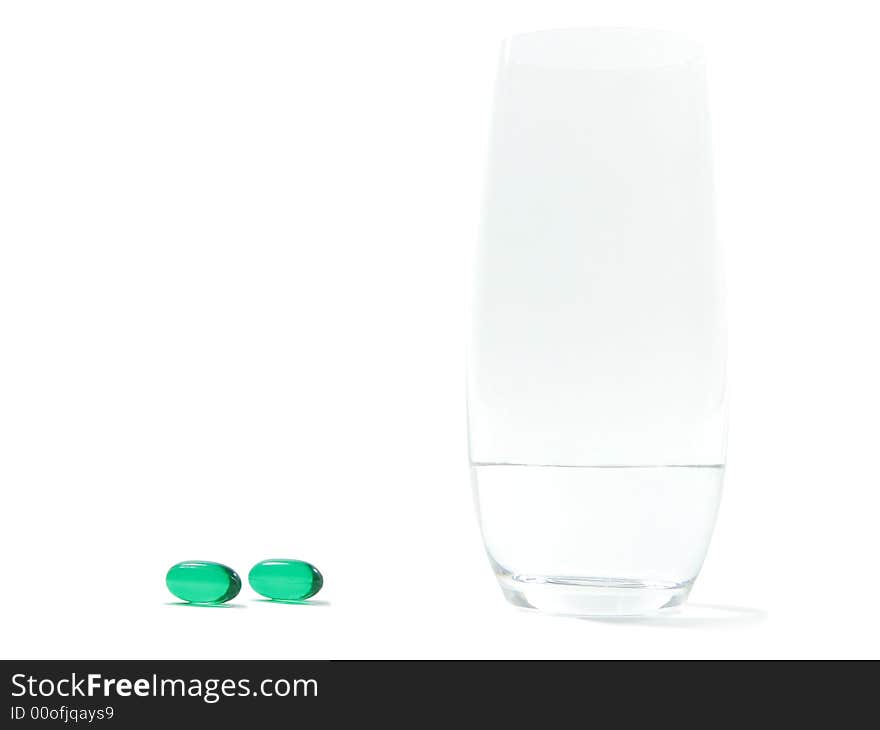 Soft gel pills and a glass