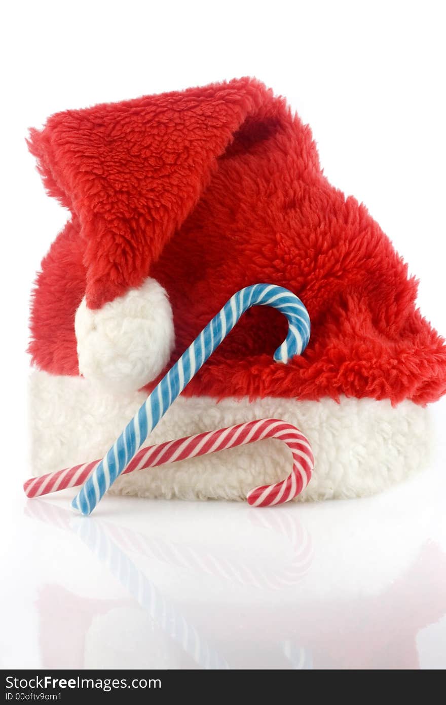 Candy cane and red cap isolated on white background