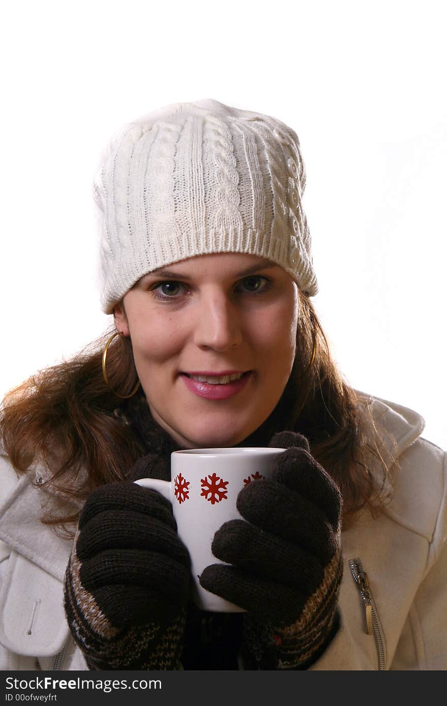 A young woman holding a cup of tea in winterclothes. Isolated over white space (for text). A young woman holding a cup of tea in winterclothes. Isolated over white space (for text).