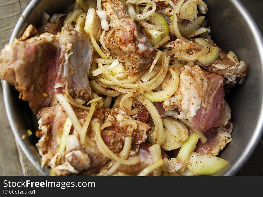 Fresh pork kebab with onion in the pan 11. Fresh pork kebab with onion in the pan 11