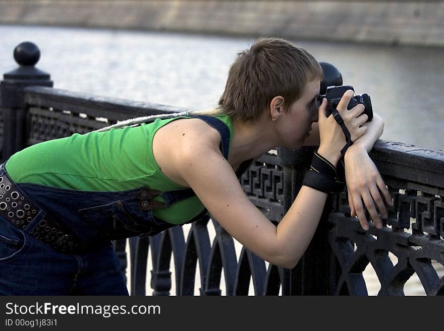 Young woman photographer making shots. Young woman photographer making shots