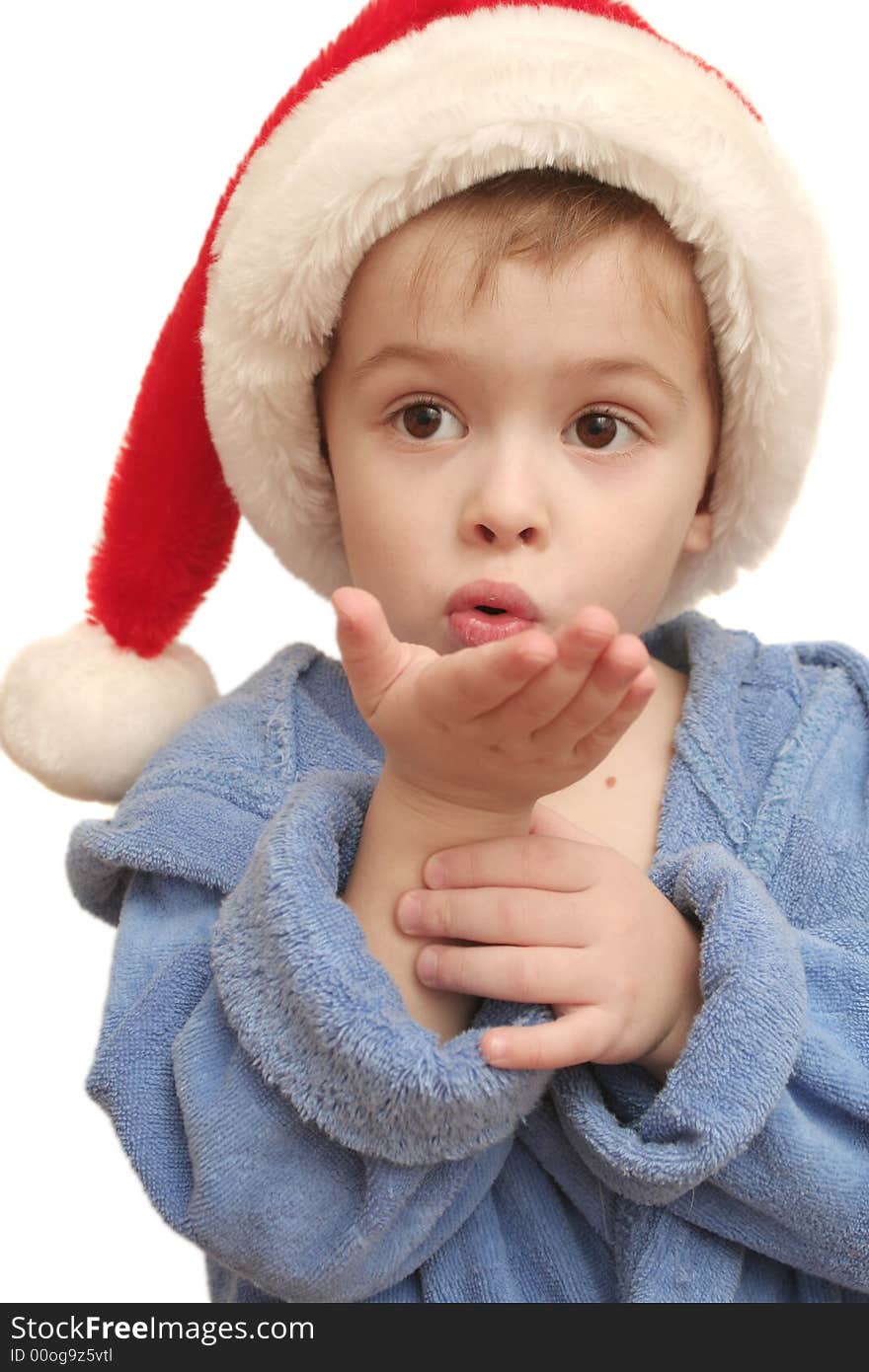 The nice boy in a New Year's cap on a white background