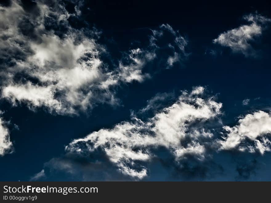 A high contrast photograph of the sky filled with clouds. A high contrast photograph of the sky filled with clouds