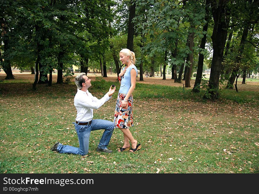 Guy proposing his girlfriend in the park. Guy proposing his girlfriend in the park