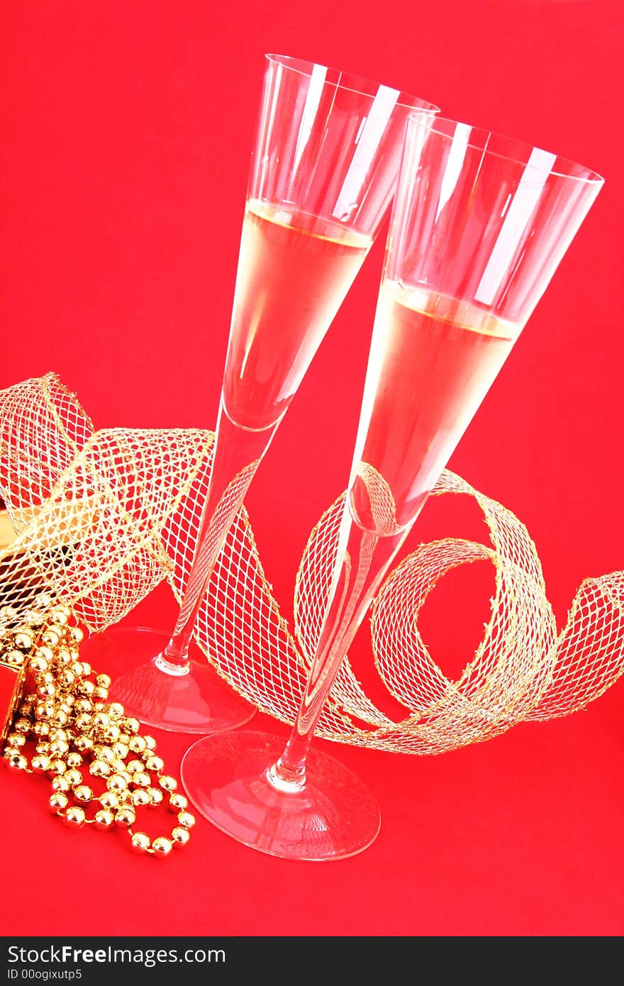 Two glasses of champagne on red background