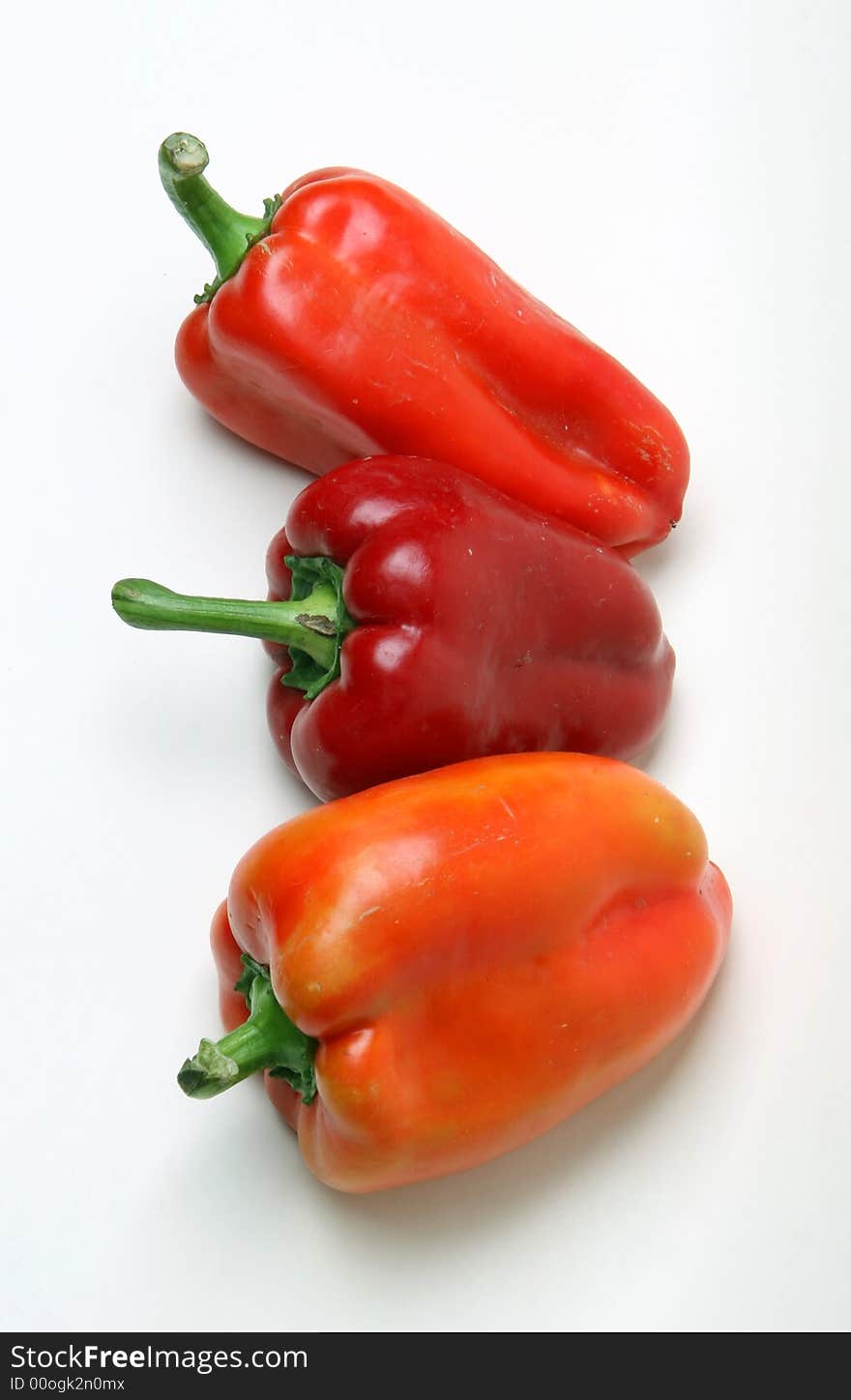 Red peppers over white background