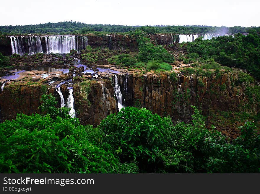 The Iguassu (or Iguazu) Falls is one of the largest masses of fresh water on the planet and divides, in South America, Brazil, Paraguay and Argentina. The waterfall system consists of 275 falls along 2.7 kilometres (1.67 miles) of the Iguazu River. Some of the individual falls are up to 82 metres (269 feet) in height, though the majority are about 64 metres (210 feet). The Iguassu (or Iguazu) Falls is one of the largest masses of fresh water on the planet and divides, in South America, Brazil, Paraguay and Argentina. The waterfall system consists of 275 falls along 2.7 kilometres (1.67 miles) of the Iguazu River. Some of the individual falls are up to 82 metres (269 feet) in height, though the majority are about 64 metres (210 feet).