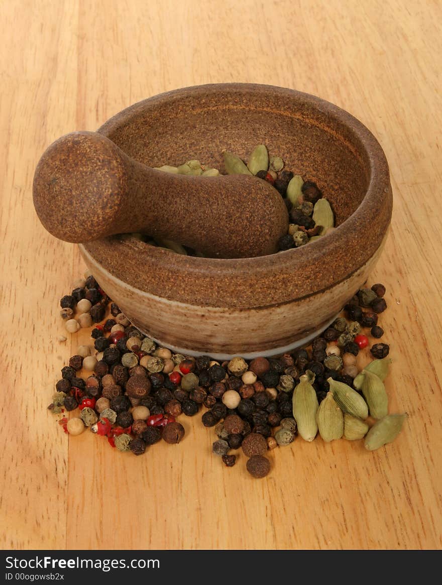 Pestle and mortar with ingredients on wooden board