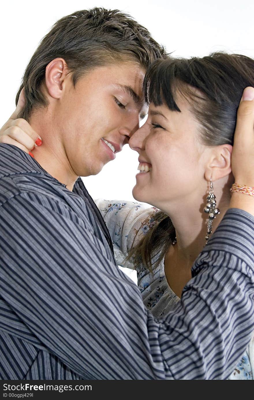 Cute young couple kissing in studio. Cute young couple kissing in studio