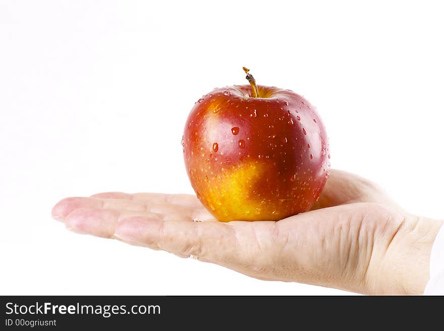 Red apple in a hand of the person