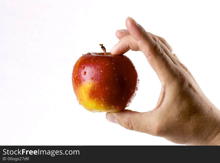 Red apple in a hand of the person