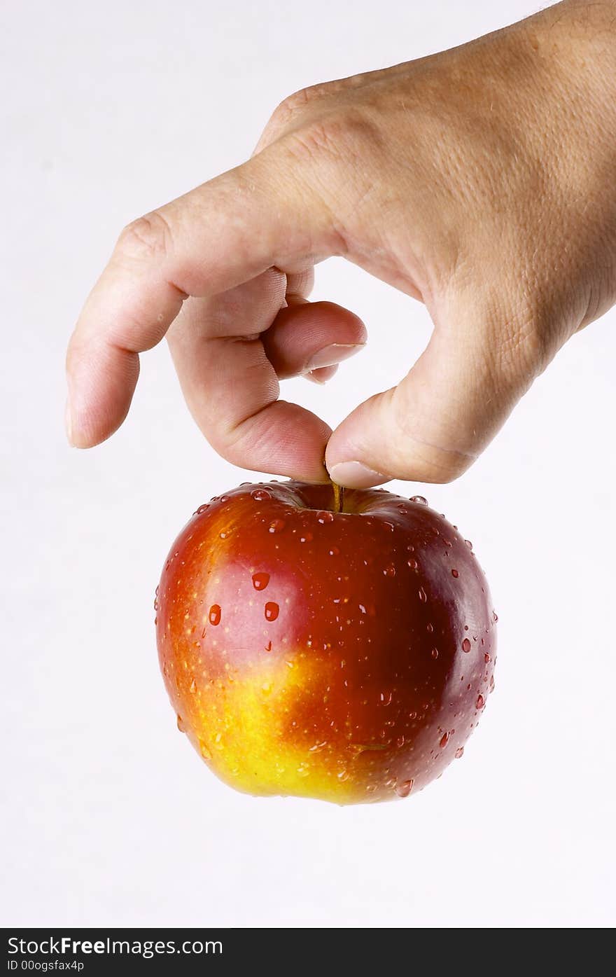 Red apple in a hand of the person