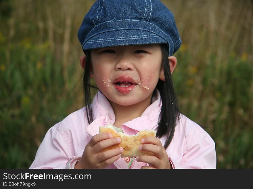 Toddler having an outdoor snack. Toddler having an outdoor snack