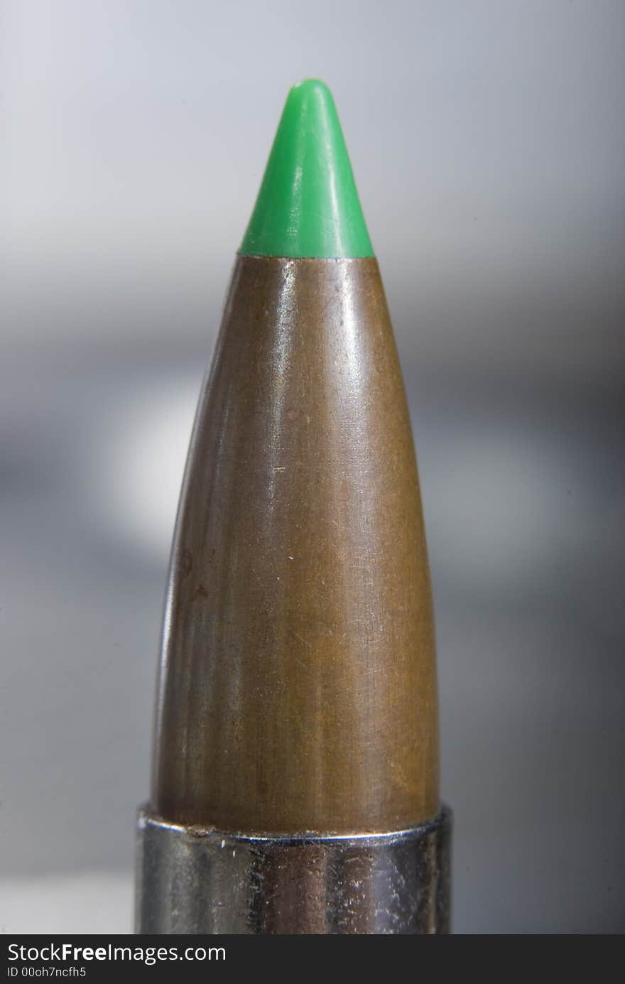 Green ballistic tip 300 mag bullet in nickel casing.