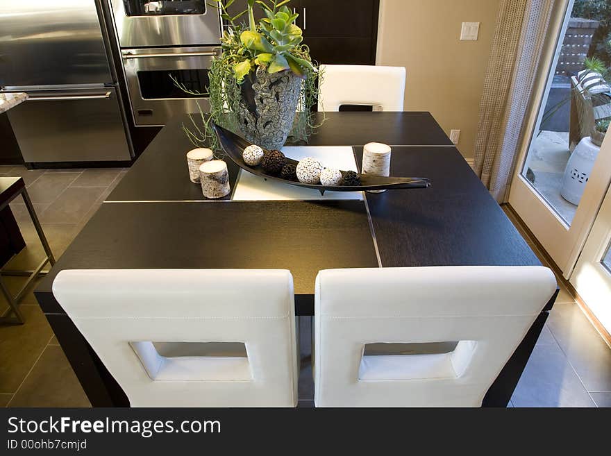 Kitchen and breakfast table with modern chairs. Kitchen and breakfast table with modern chairs.