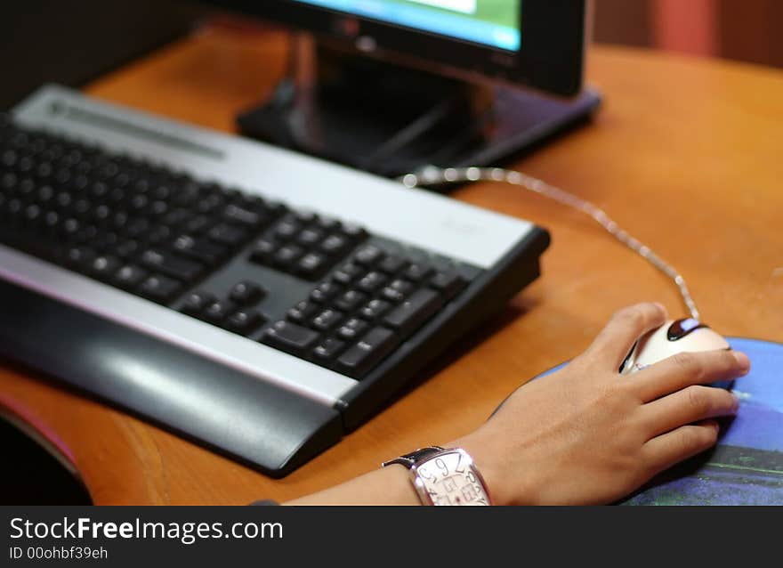 A hand holding mouse to control the computer. A hand holding mouse to control the computer